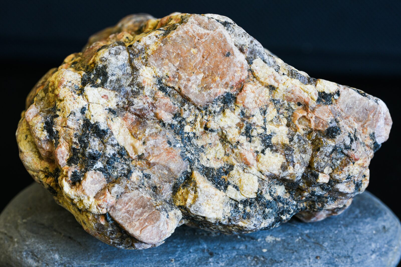 Coarse pegmatitic granite — pink K-feldspar, quartz, biotite